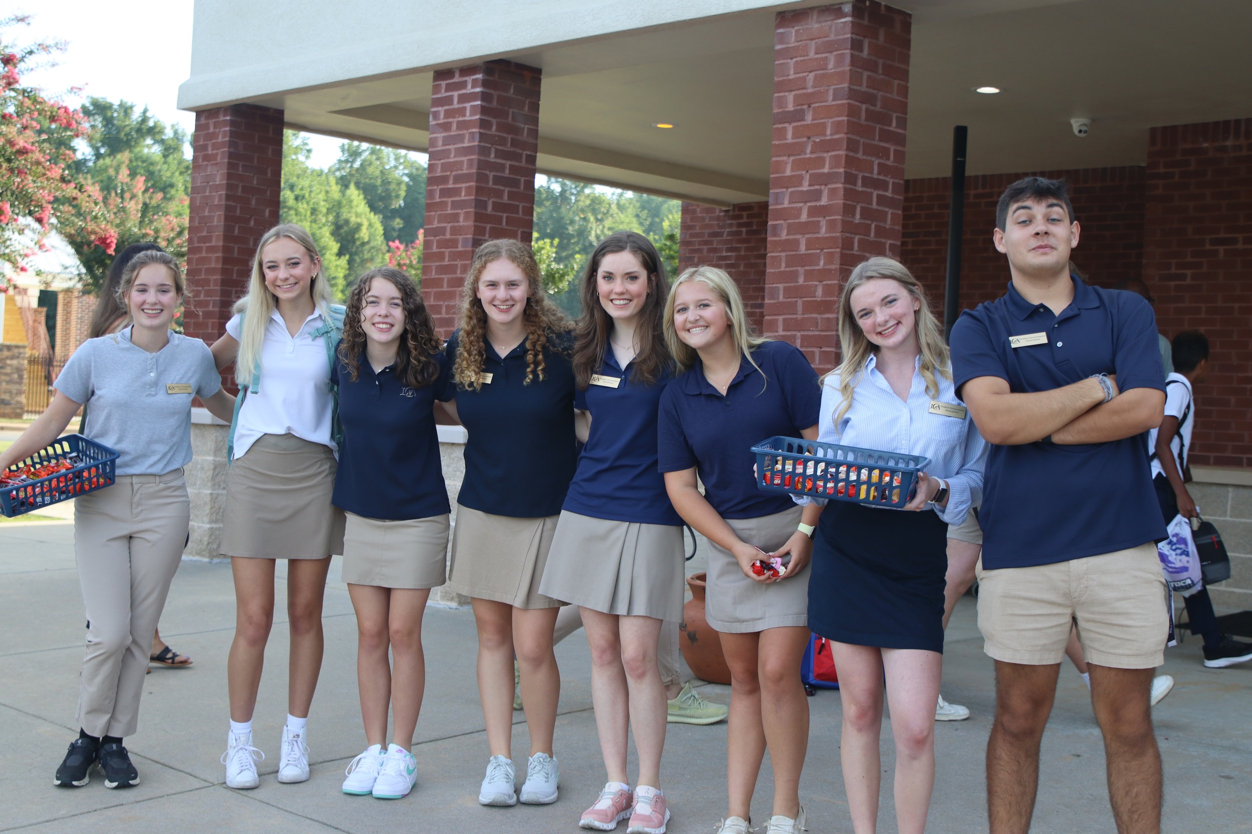 7 students standing outside school building