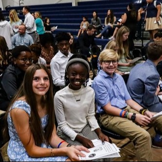 students sitting and smiling