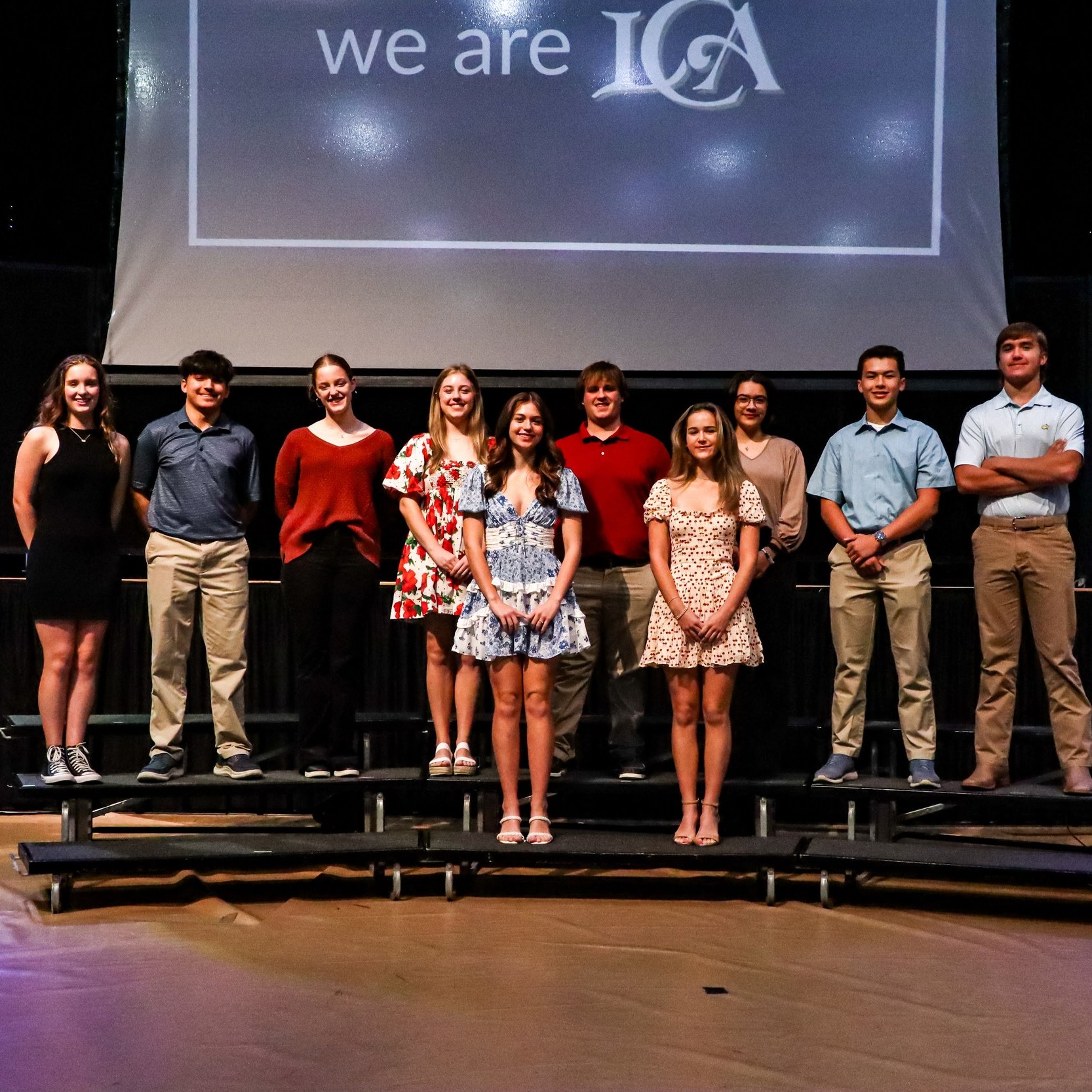 students standing on risers and smiling
