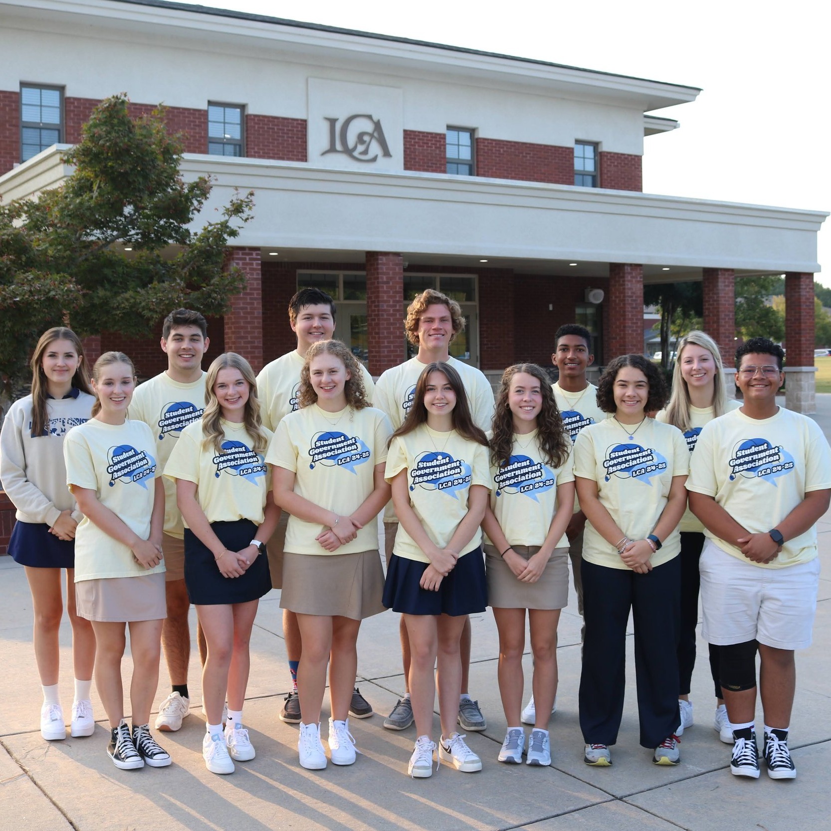 students standing in front of school building