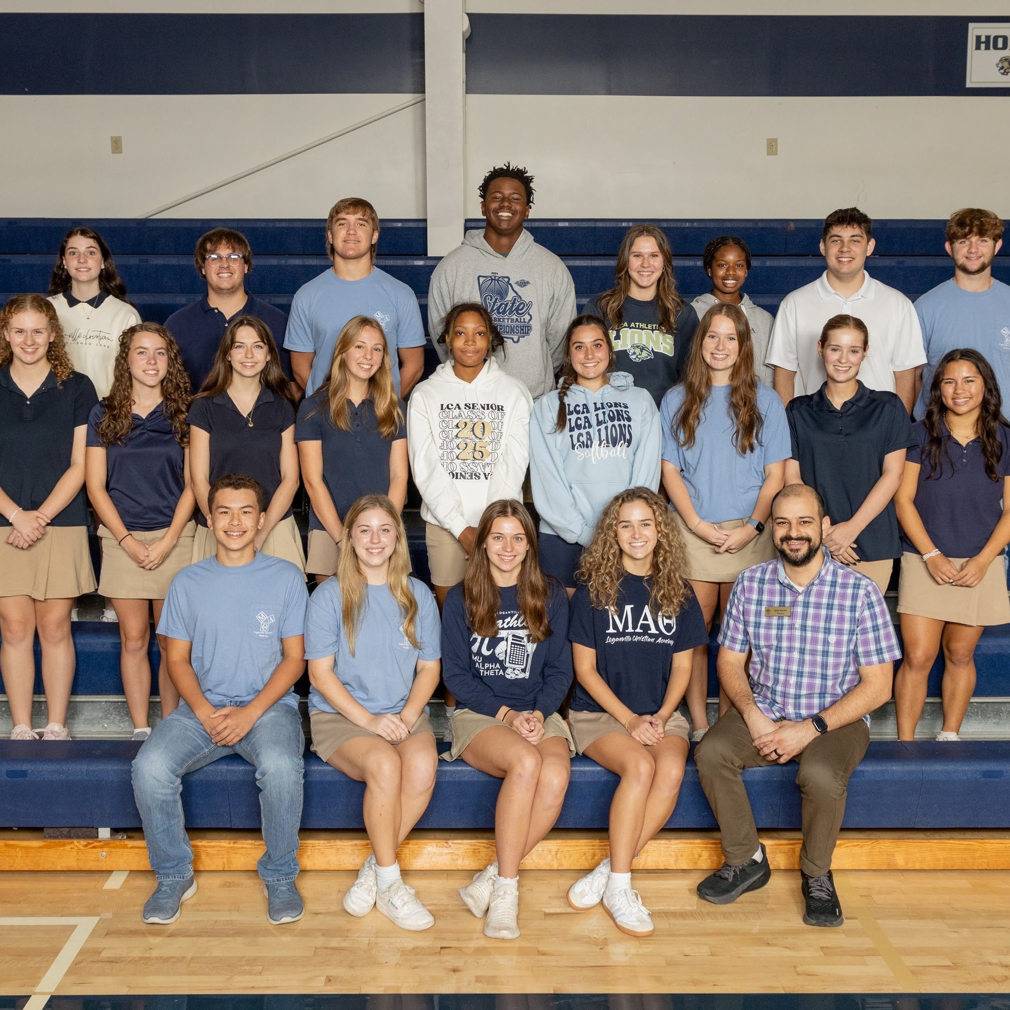 large group of students sitting on risers and smiling