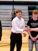  A man shakes hands with another man on a basketball court, symbolizing sportsmanship and camaraderie.