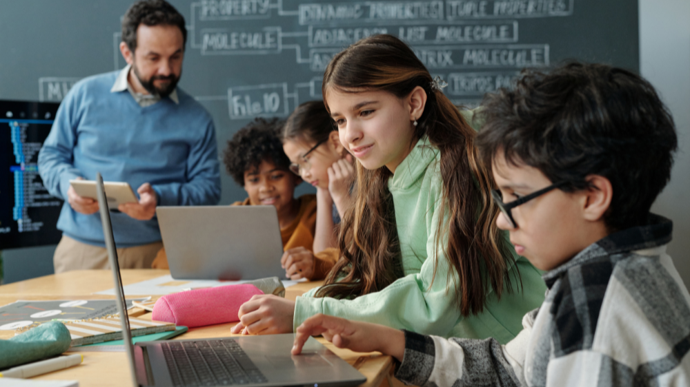 CLASSROOM OF STUDENTS WORKING AT A DESK