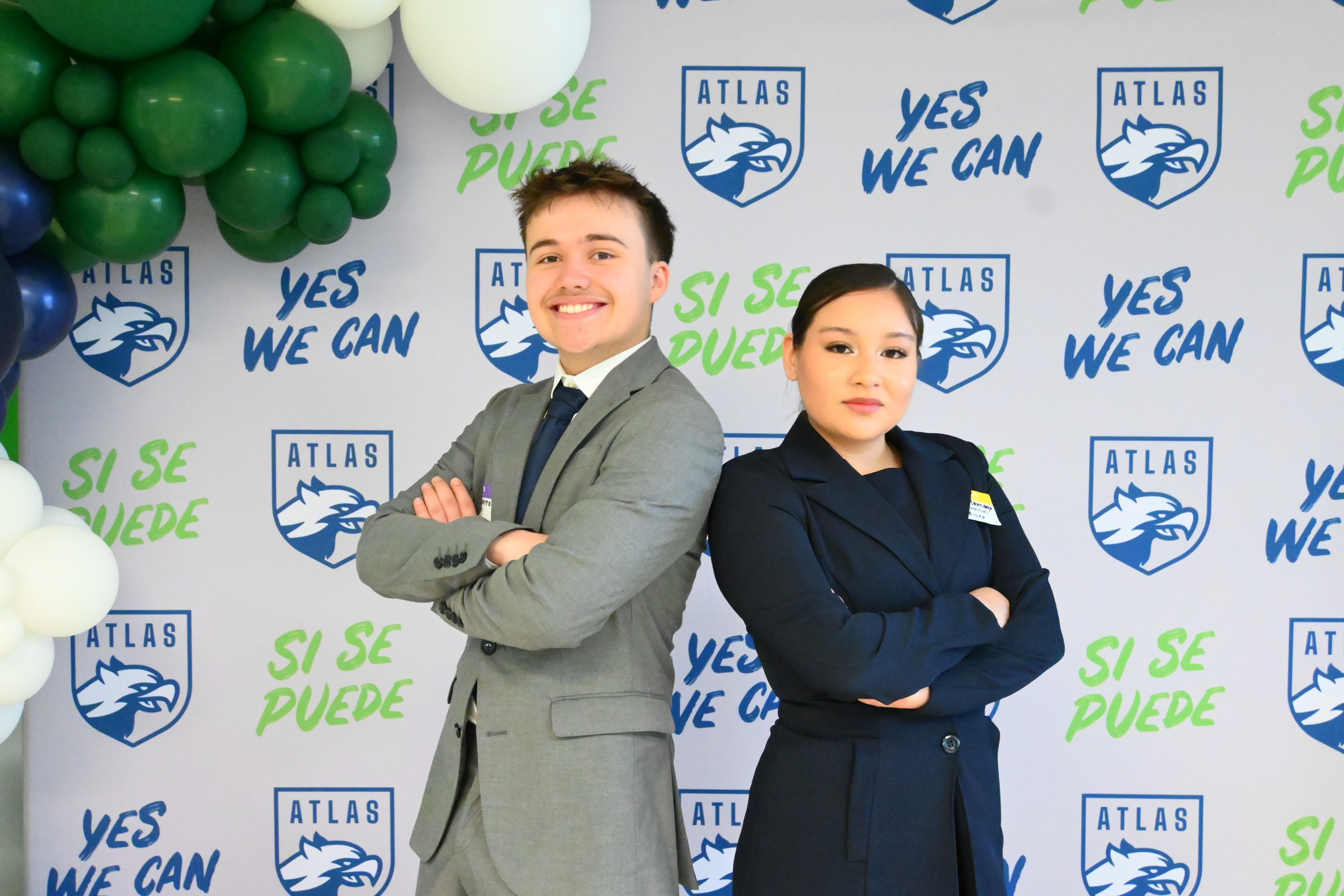two students stand proud