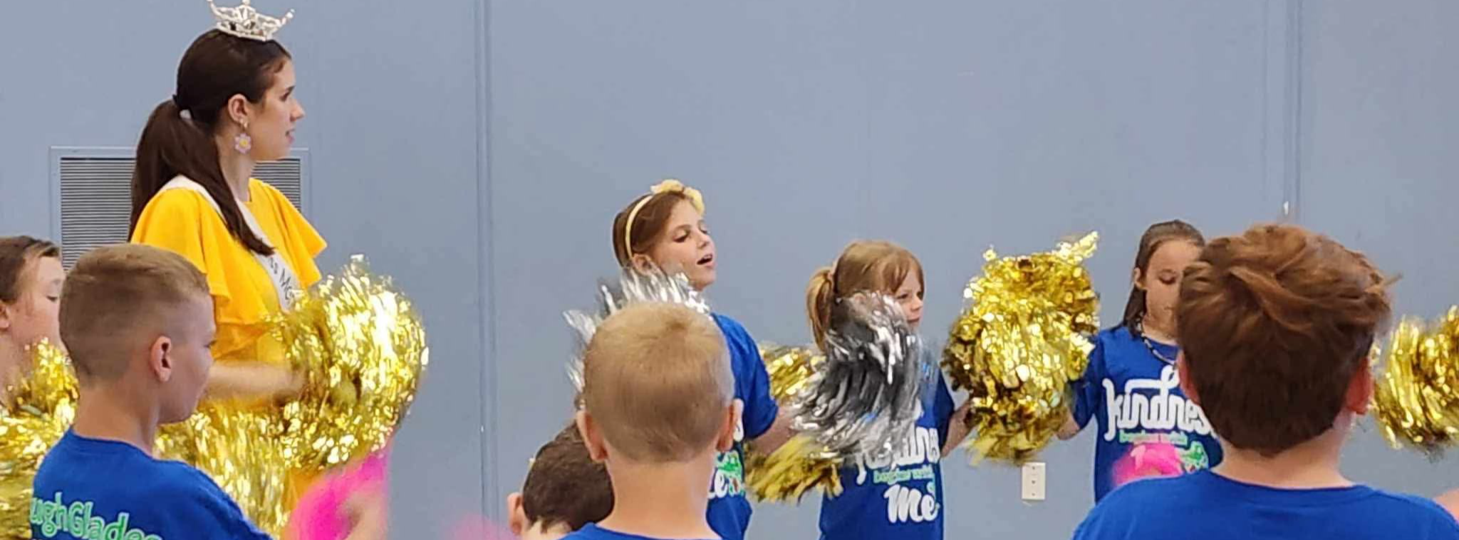 Students participate in a cheer with Ms. Carly Lawson.