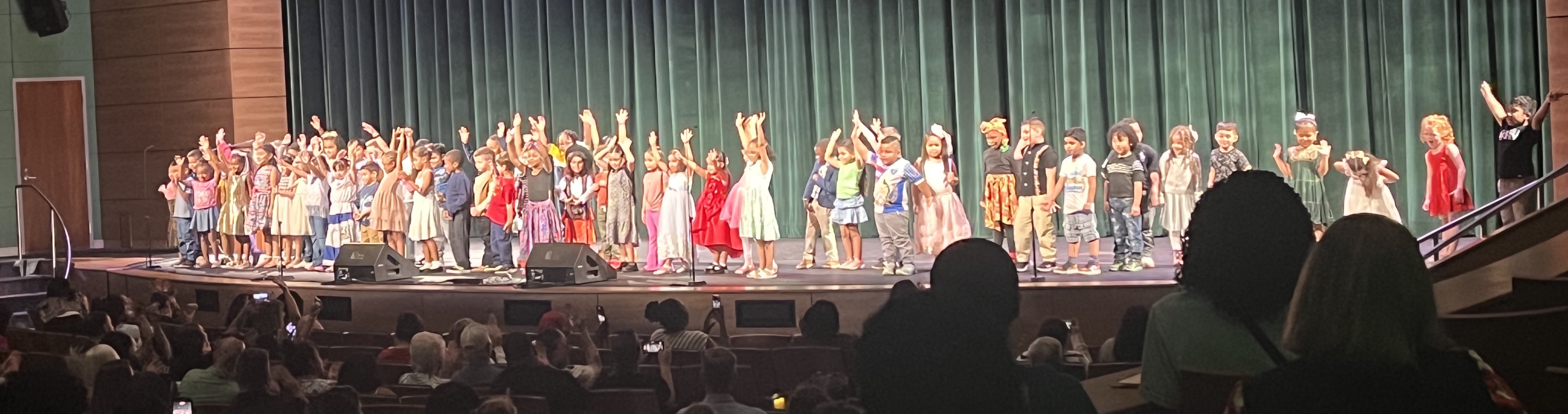 Line of elementary age students on PAC stage