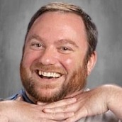 Headshot of Richard Narducci smiling and holding his hands under his chin