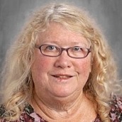 Headshot of Diane Ringler, wearing glasses and smiling