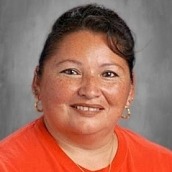 Headshot of Heidi Gilbert, smiling and wearing earrings