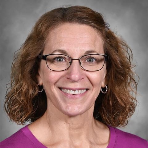 Headshot of Joy Krammer Smiling and wearing glasses