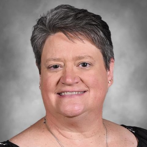 Headshot of Melanie Brown smiling wearing necklace