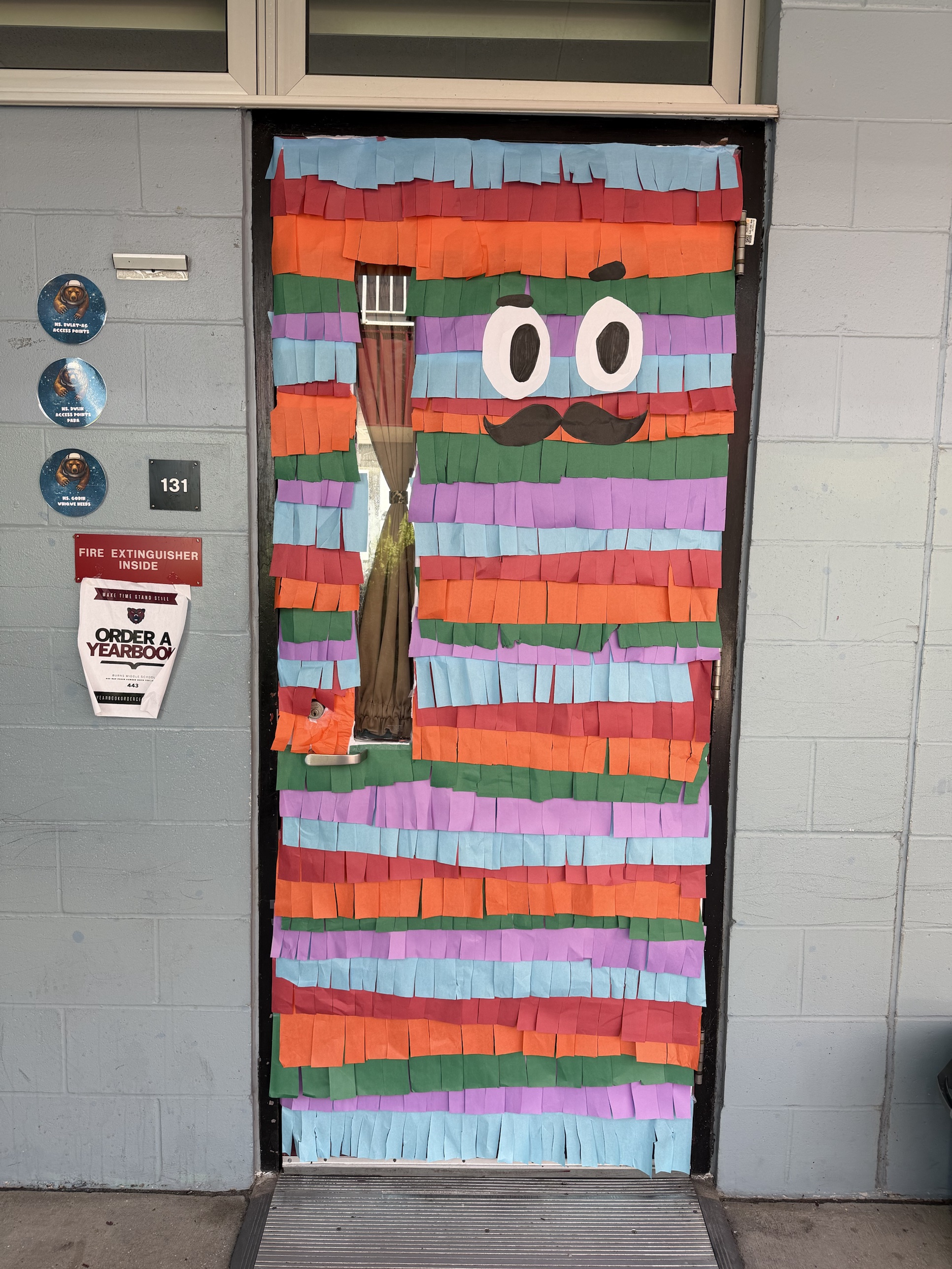 Classroom door decorated as a colorful piñata for Hispanic Heritage Month at Burns Middle School