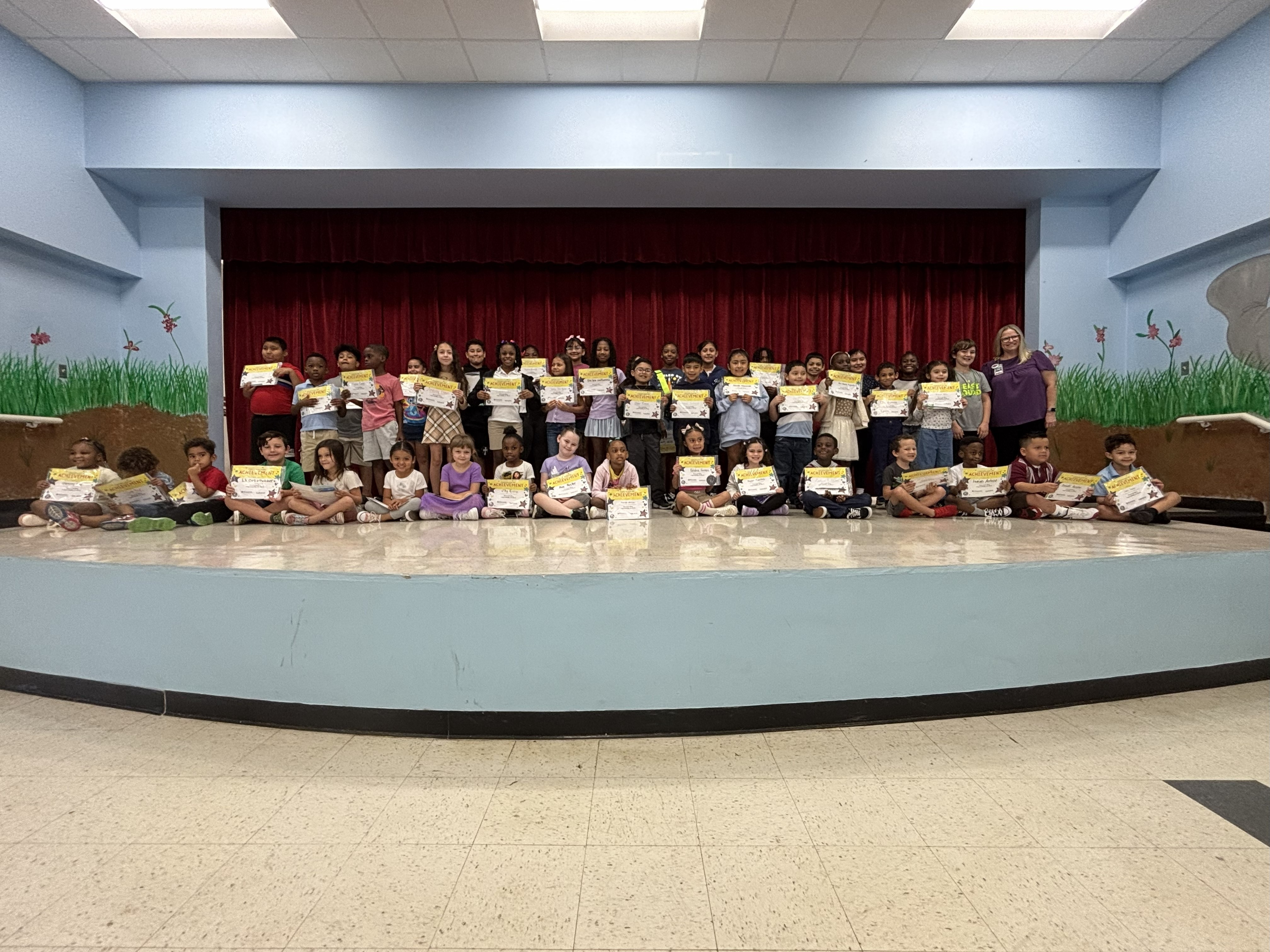 students on stage with award