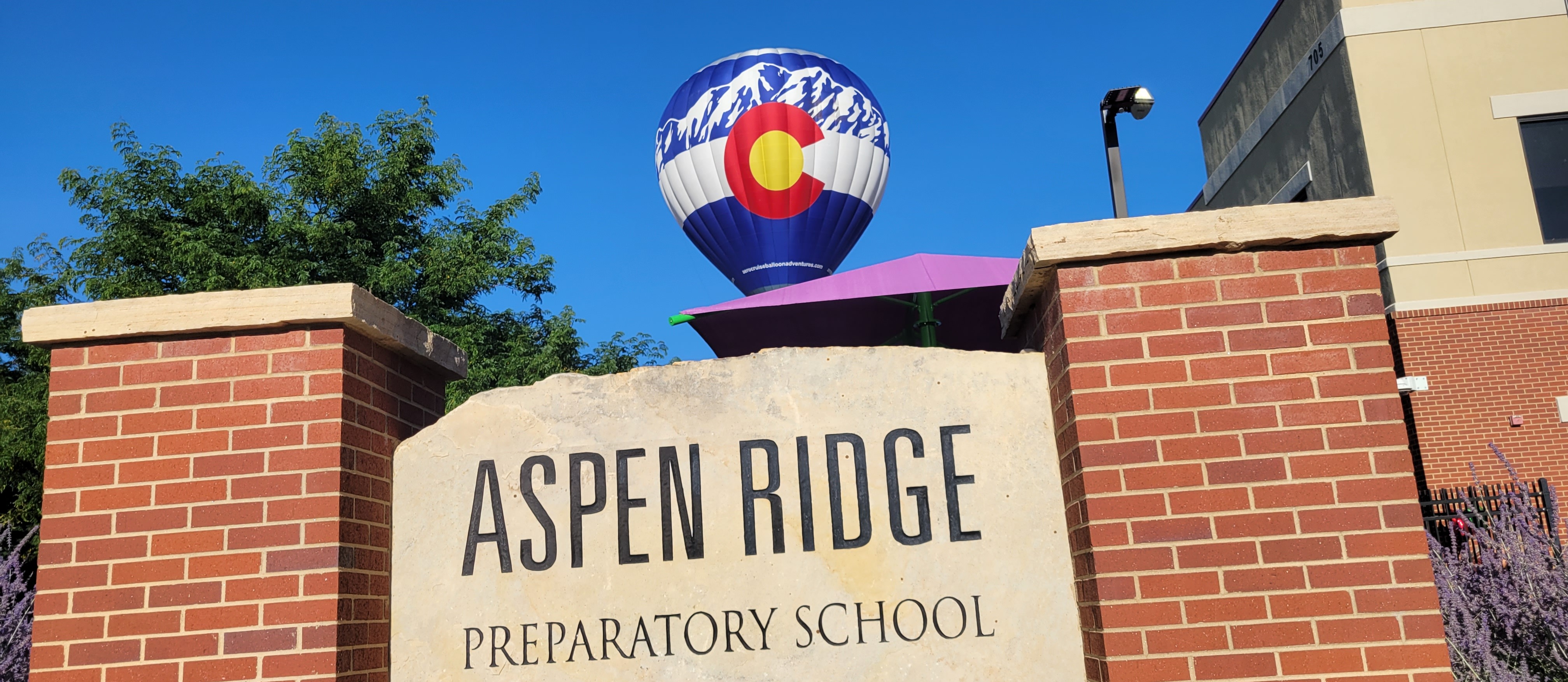 Hot air balloon over ARPS sign
