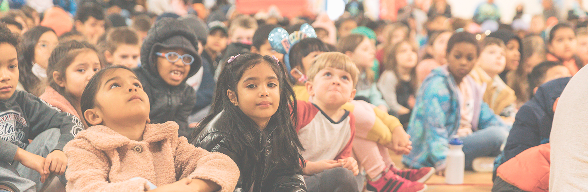 students sitting at an assembly