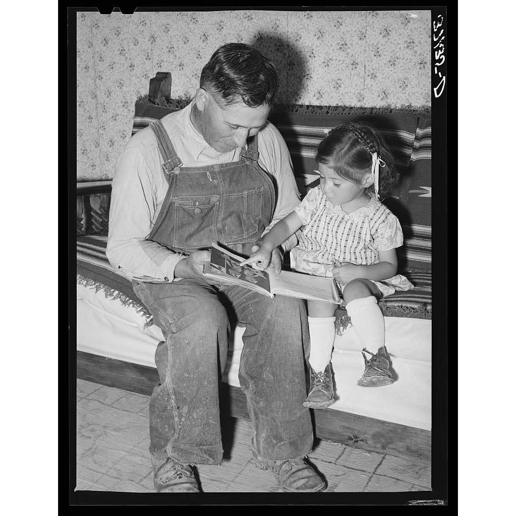 Chamisal farmer teaches his daughter to read.