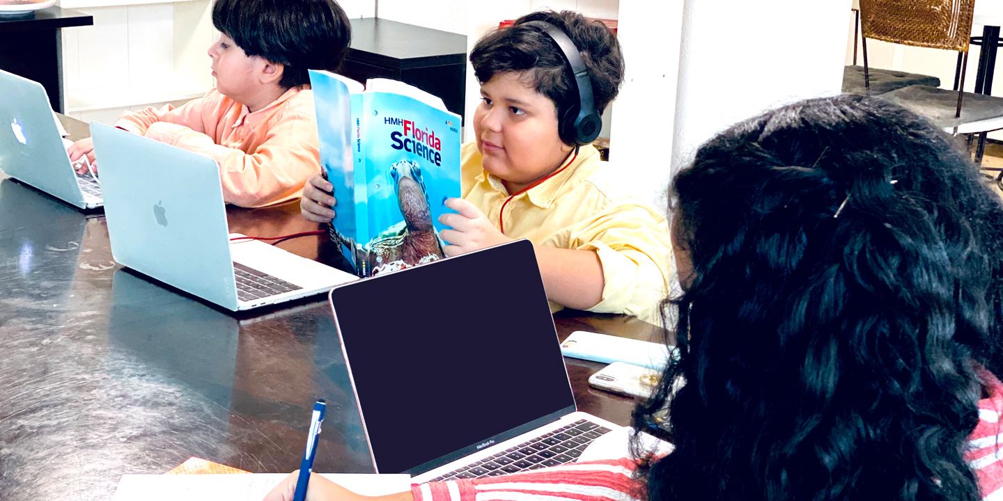 Students learning virtually on a computer