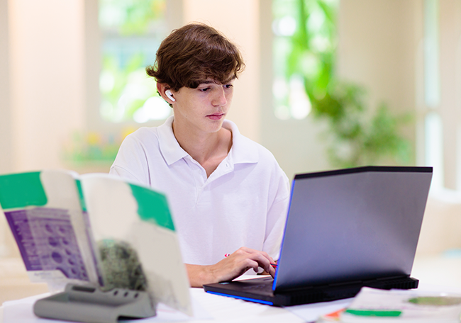 student working on laptop at home