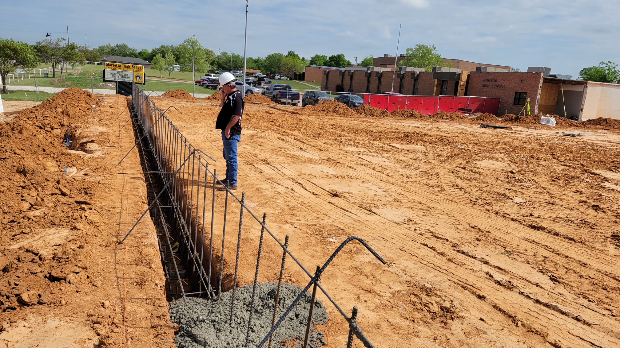 Jeral Berry inspects footings for new high school building.