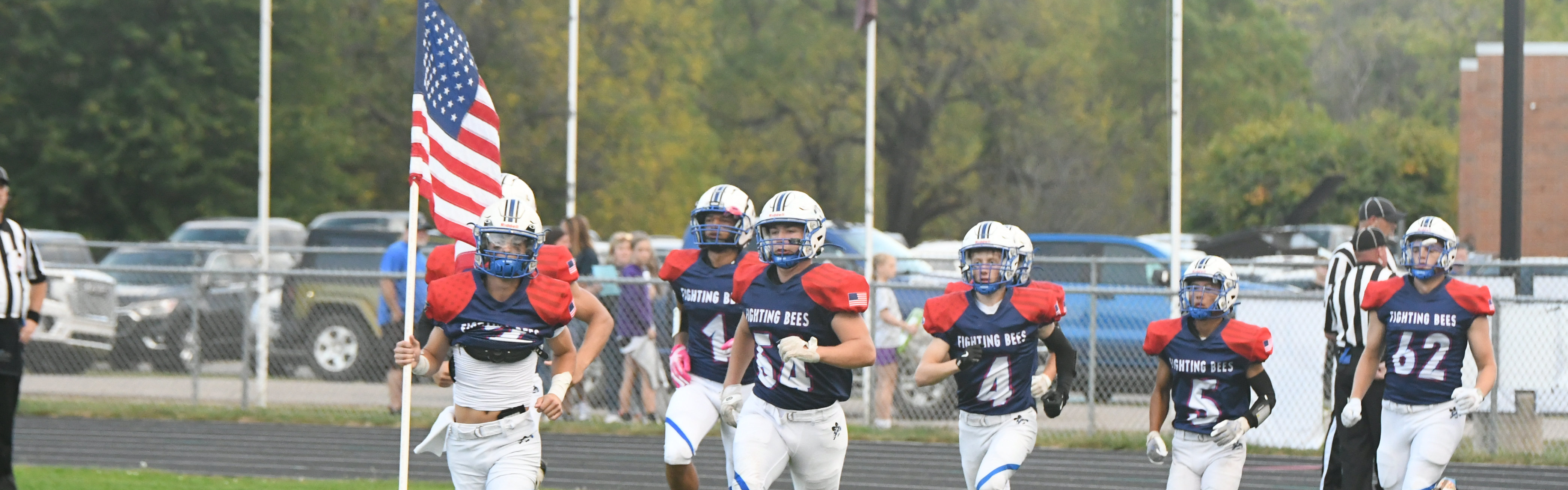 Football team running on field