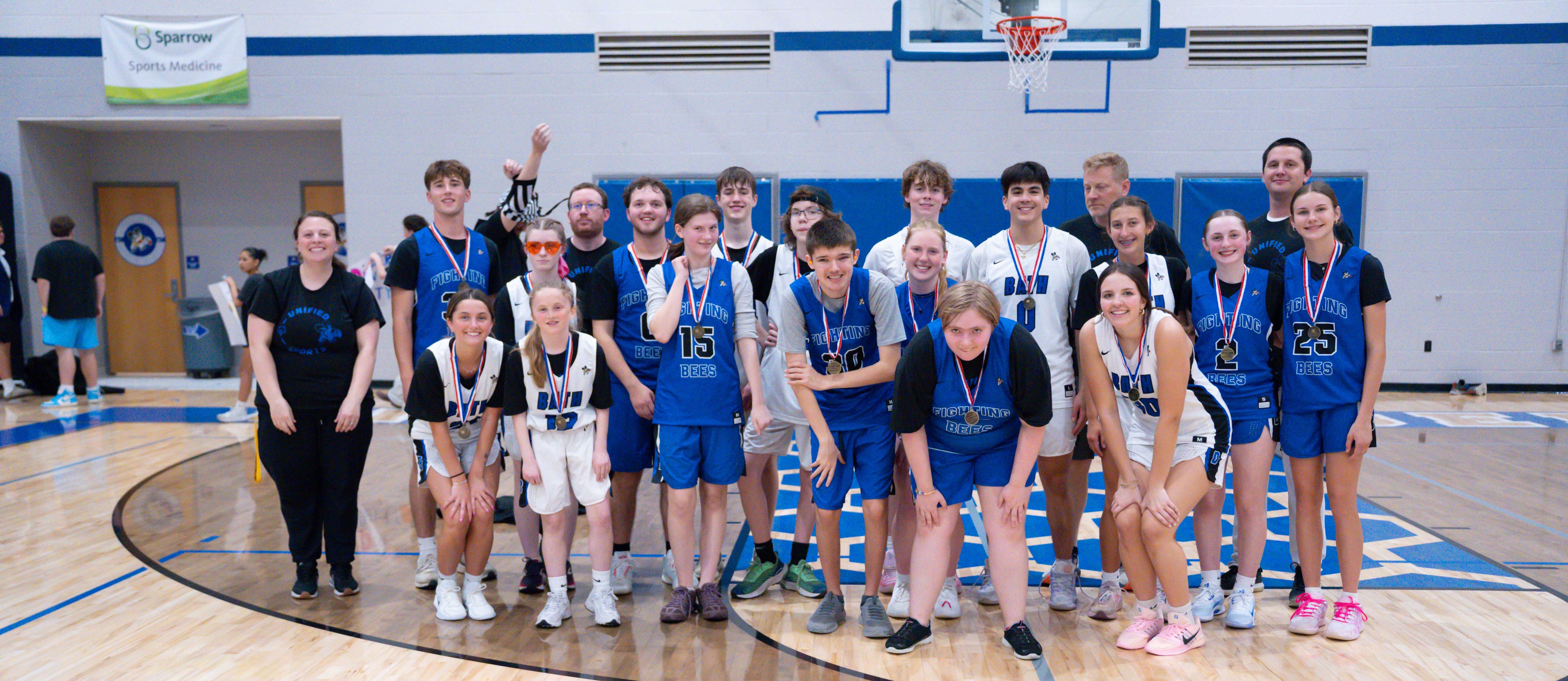 Unified team members standing together on the basketball court