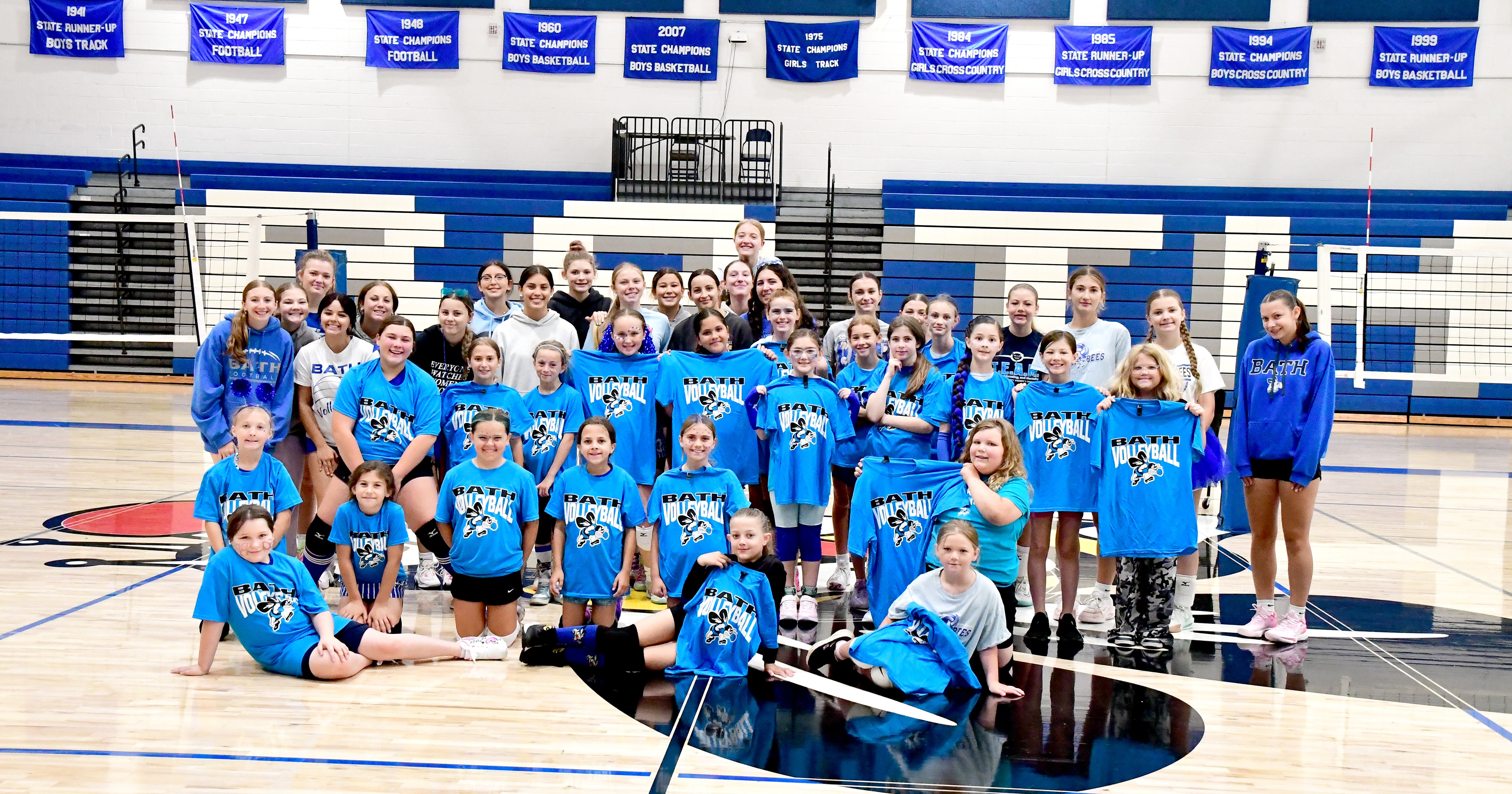 Volleyball camp participants wearing camp shirts