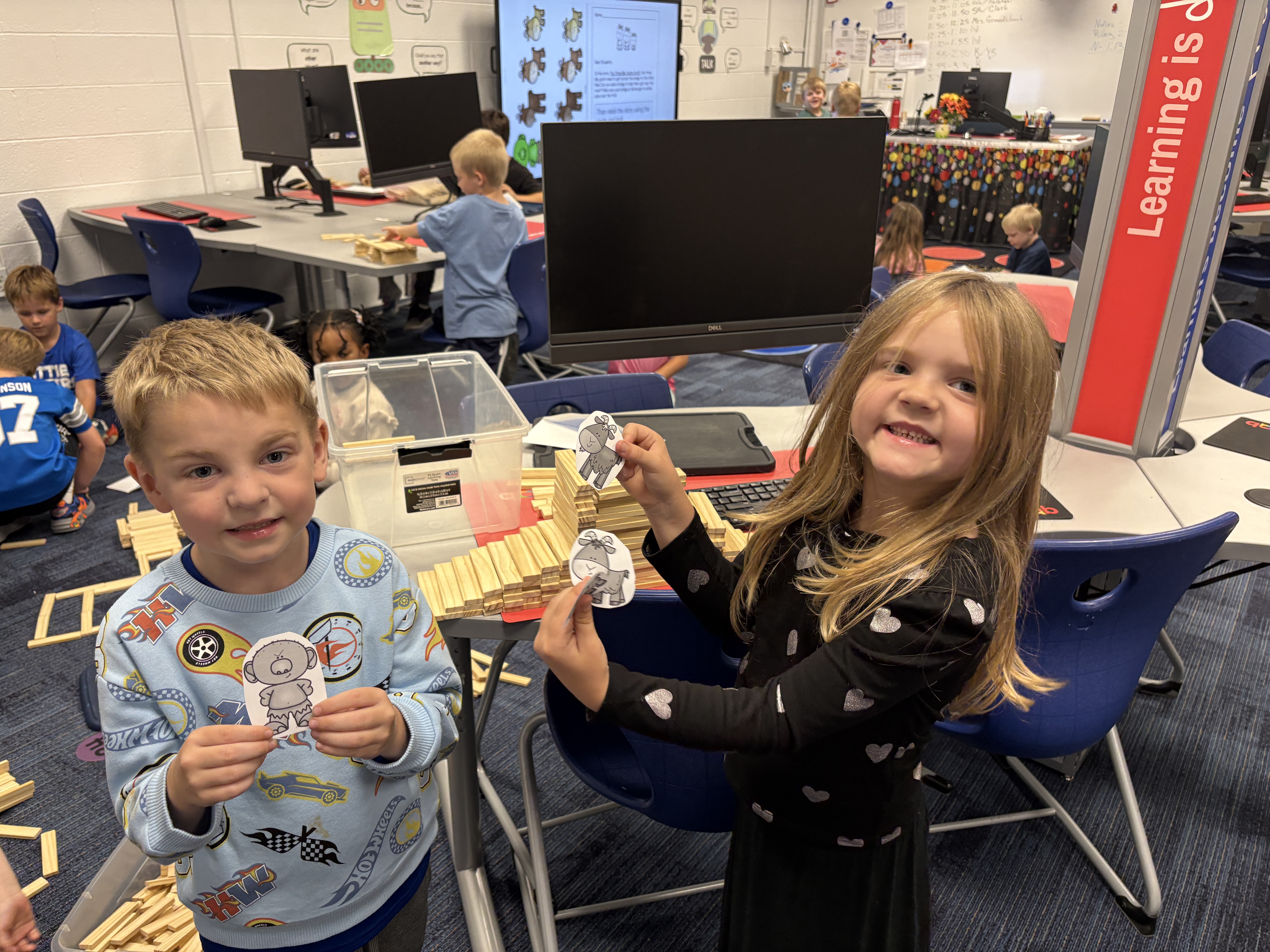 Students holding up project 