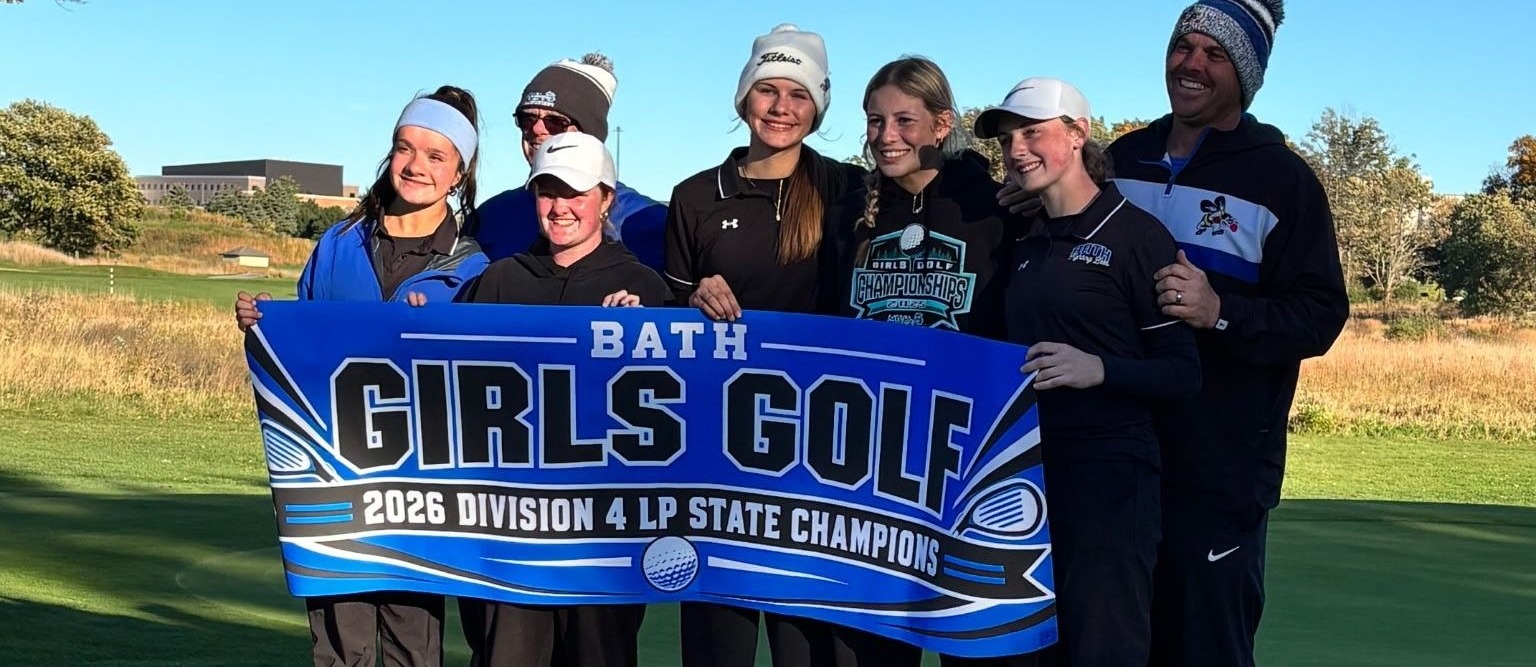 High school girls golf team and coaches holding state championship banner
