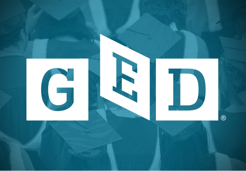 GED logo overlaid on a background of students wearing graduation caps and gowns 