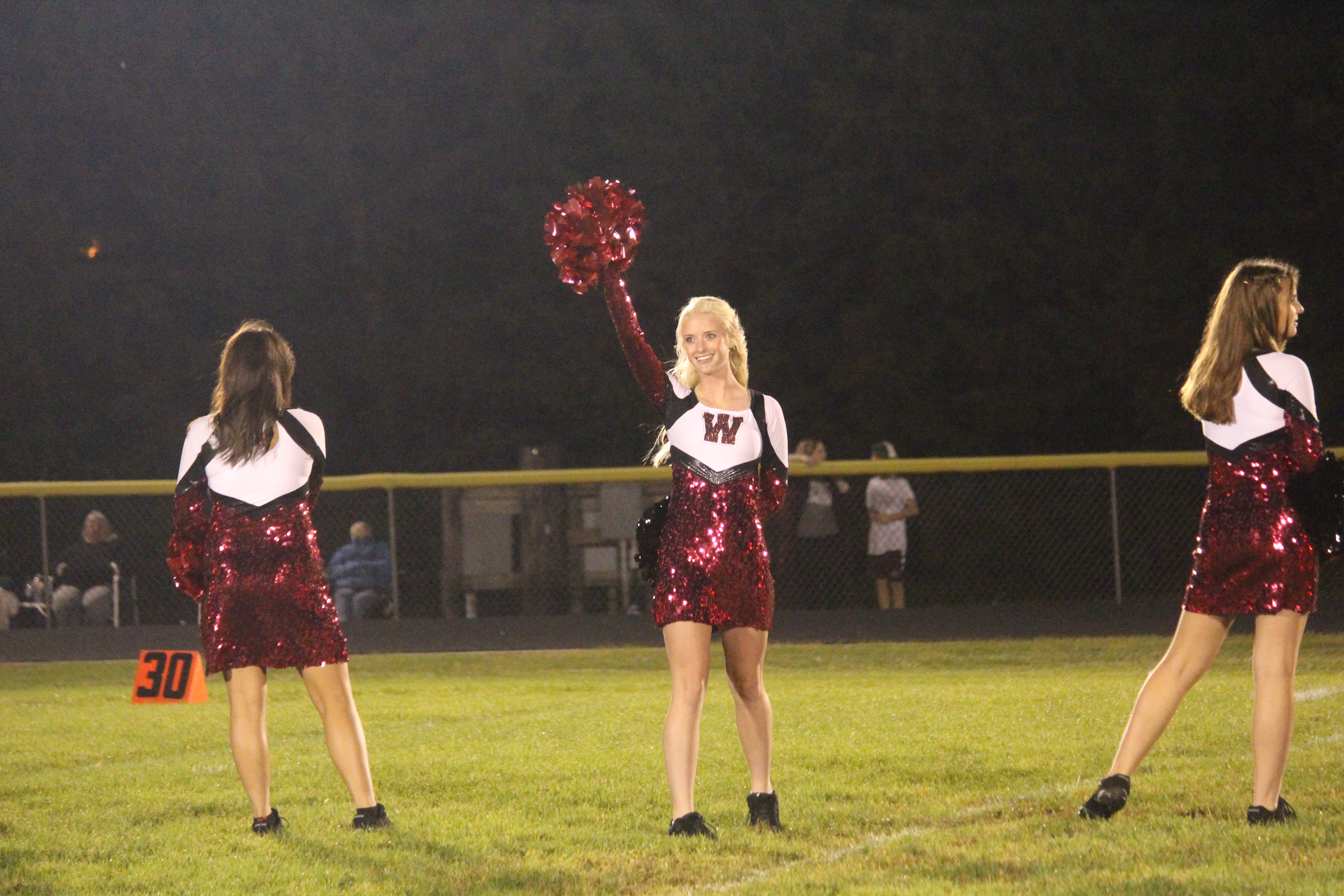 Lynae waves to the crowd as her name gets announced at the home football game against Ainsworth.