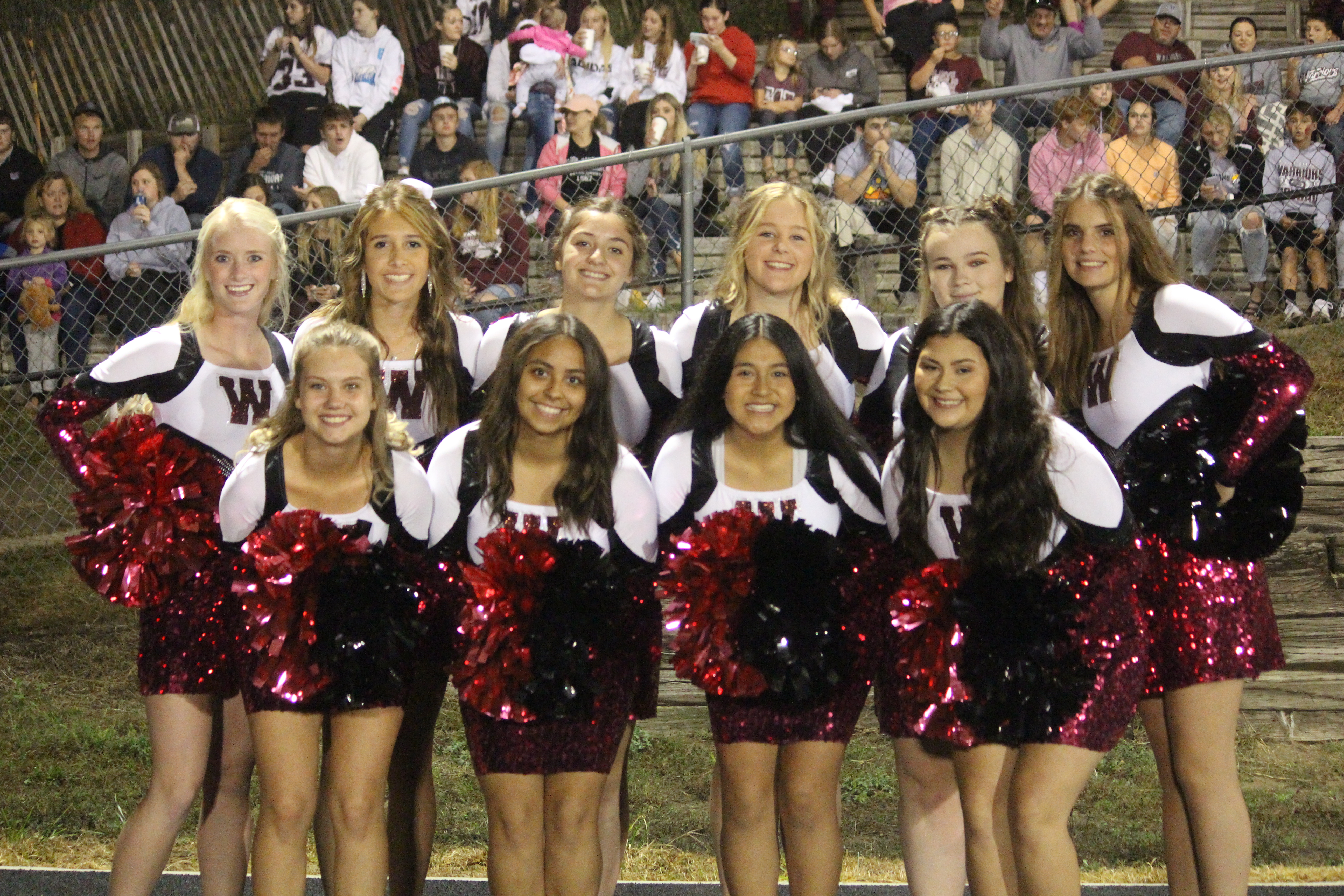 The Dance Team takes pictures as they get ready to perform at the homecoming football game at halftime.