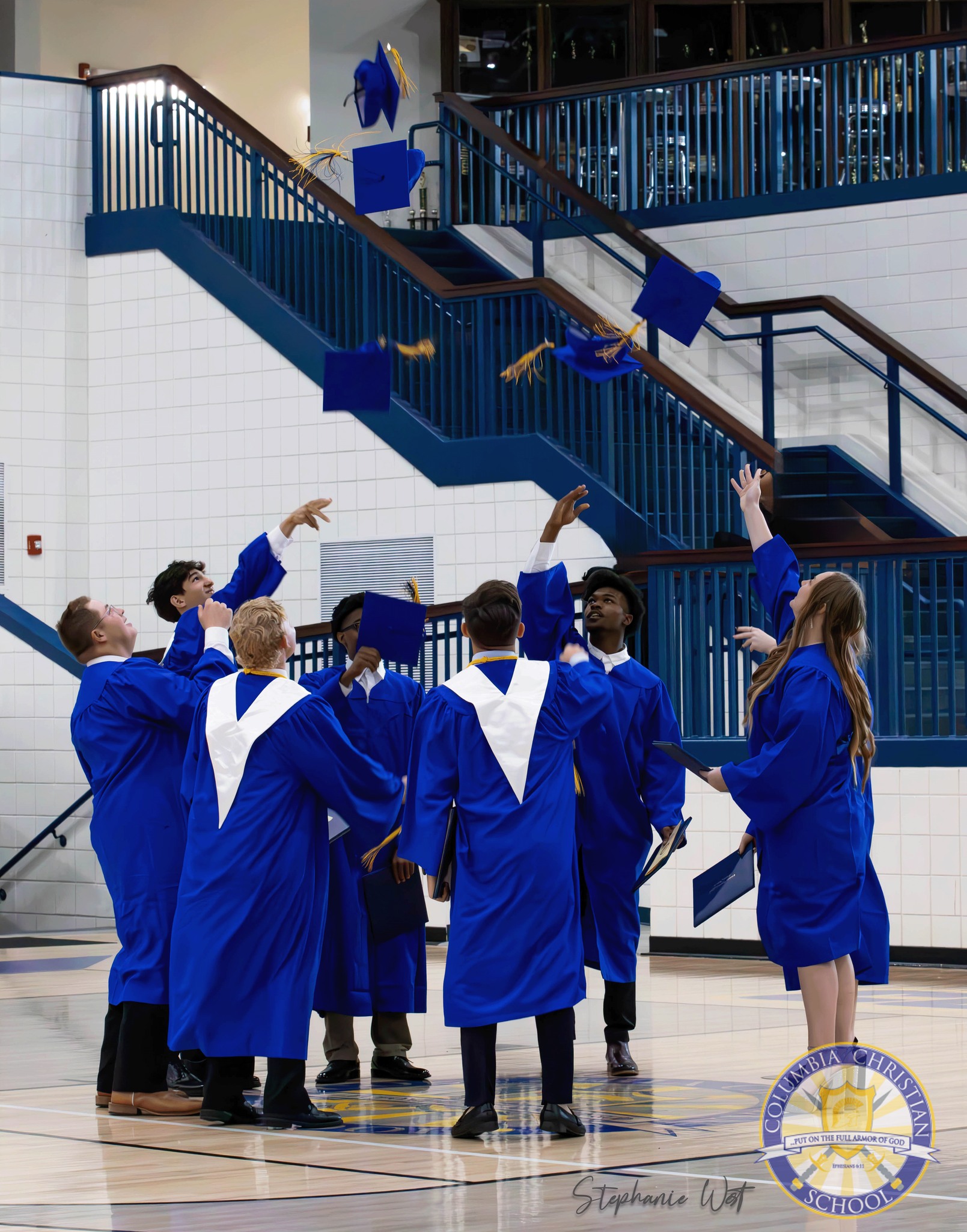 picture of high school graduates throwing their caps. 