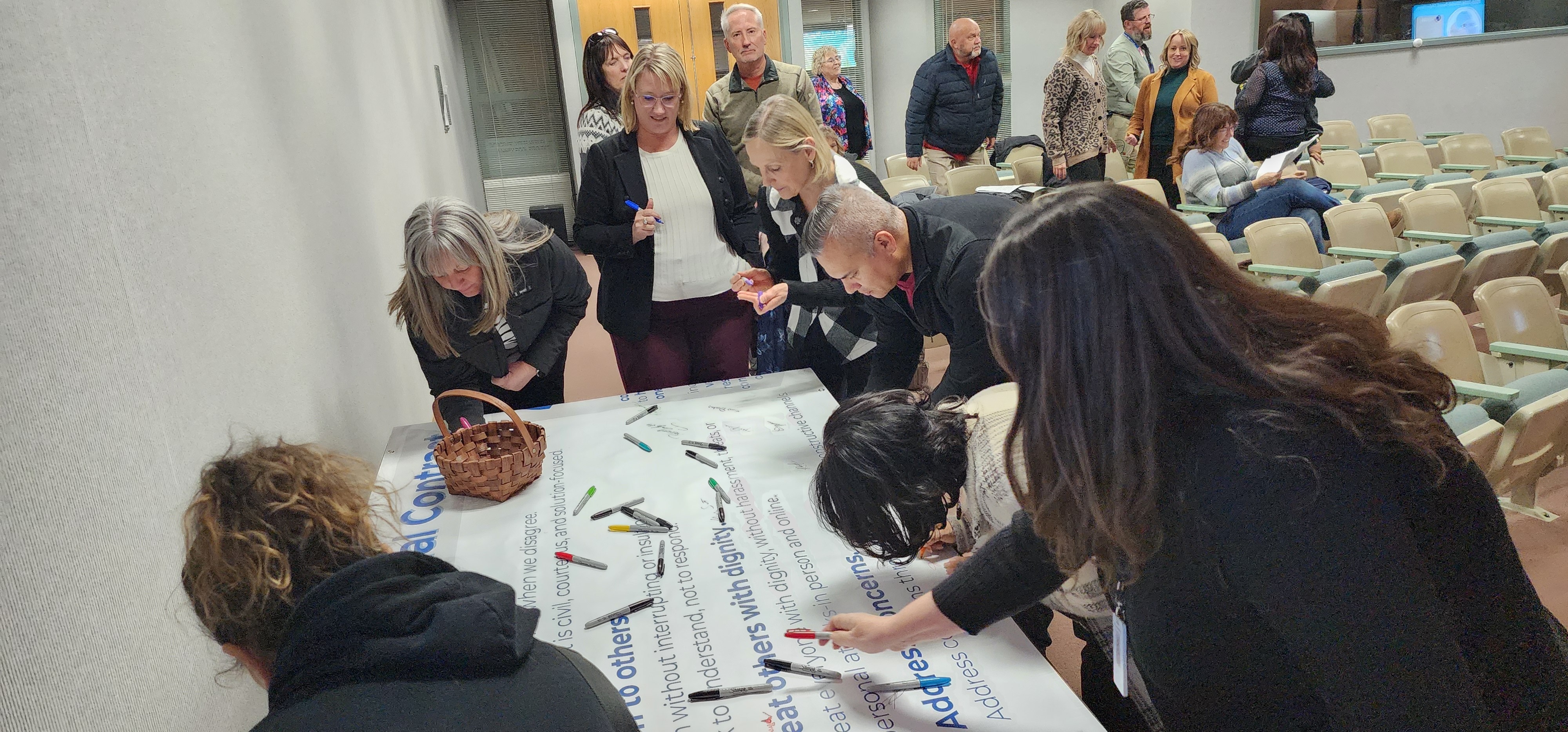 Community members signing a banner