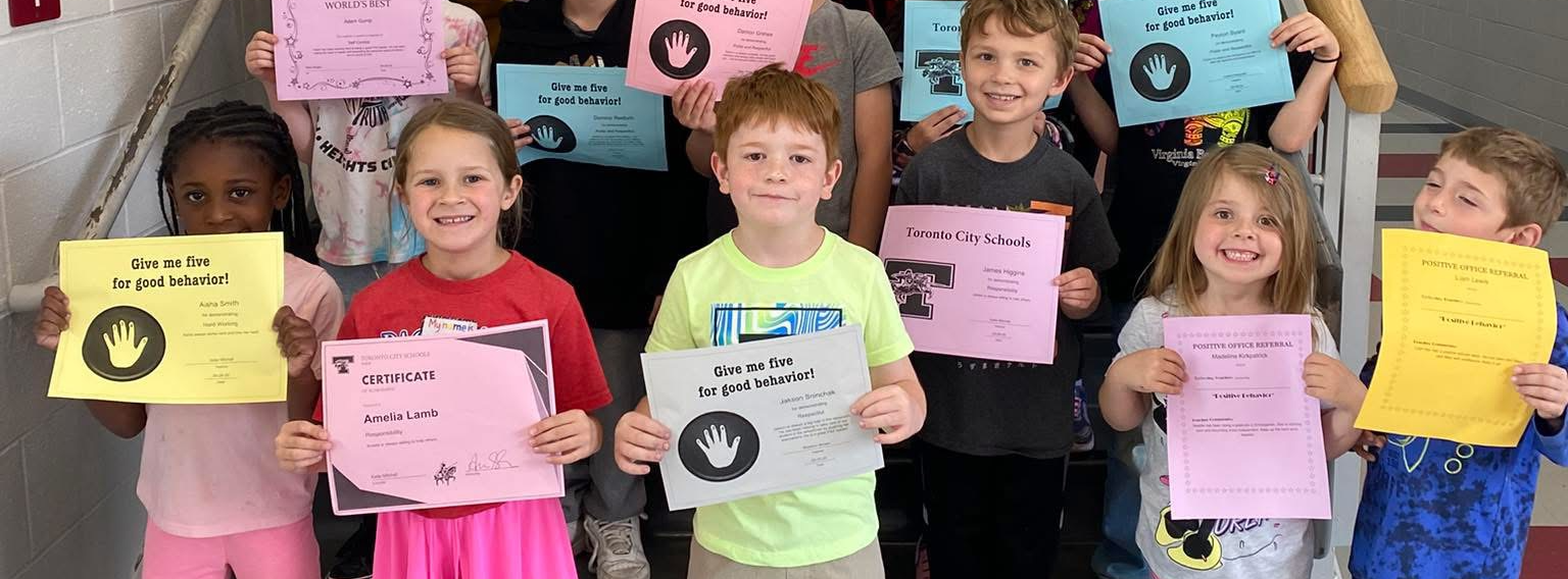 Group of students holding PBIS award certificates 