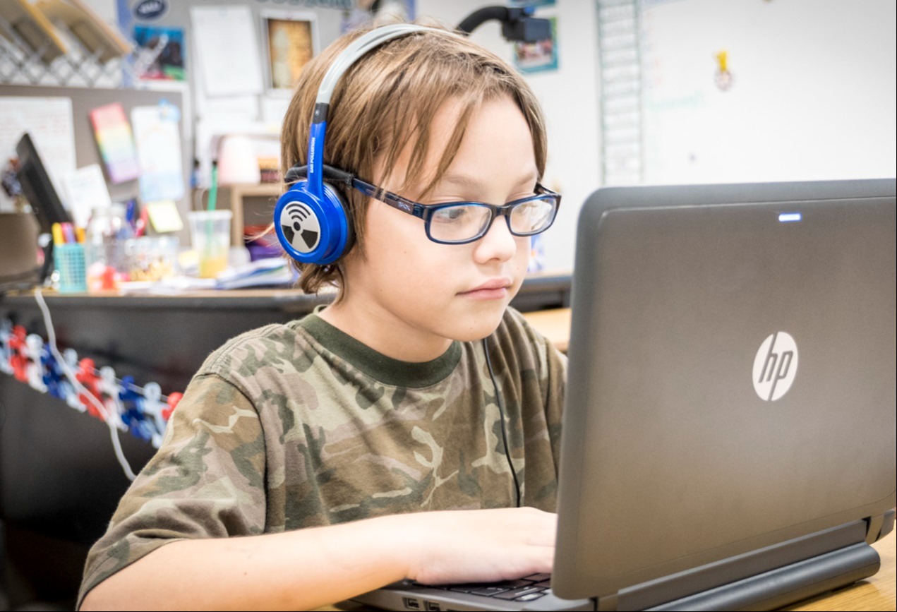 Student working on a laptop participating in an online class