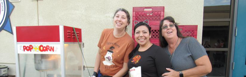 Fruitvale Staff posing together getting popcorn