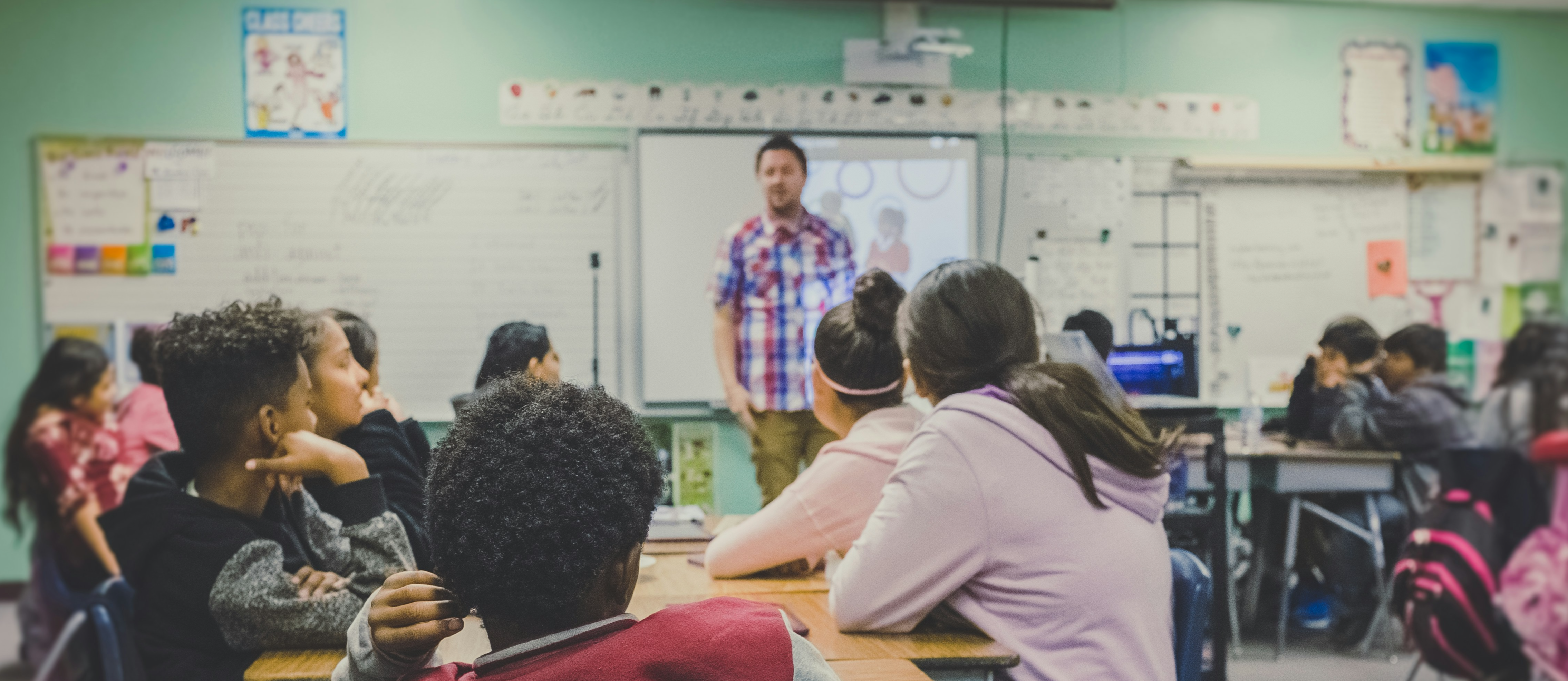 teacher in front of students in a class