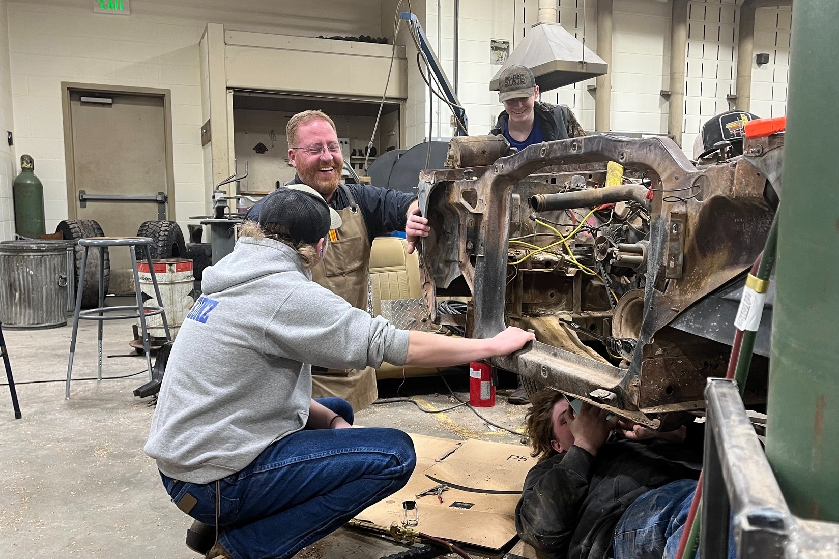 2 men working on a car engine
