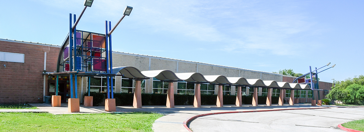 Unique entrance to Woodlawn Hills Elementary school with squiggly canopy and colorful stained glass panels above entry walkway.