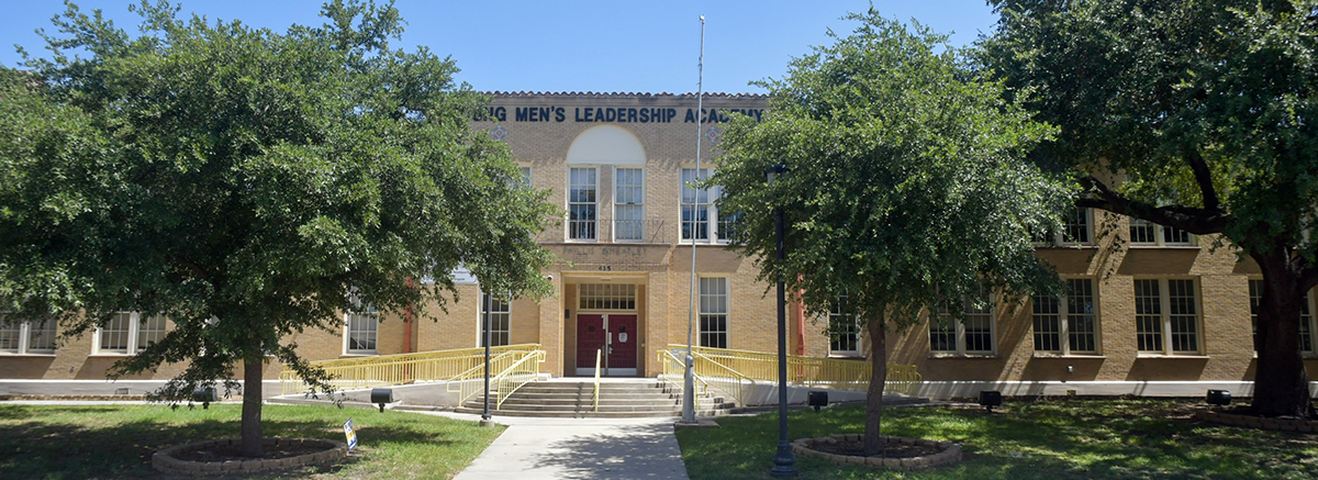 Entrance to Young Men's Leadership Academy with rounded stairs and trees on either side of side walk leading to school entrance.