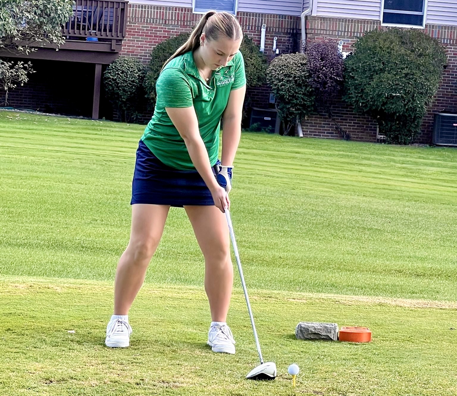 Lapeer girls golf player getting ready to hit the ball off the tee