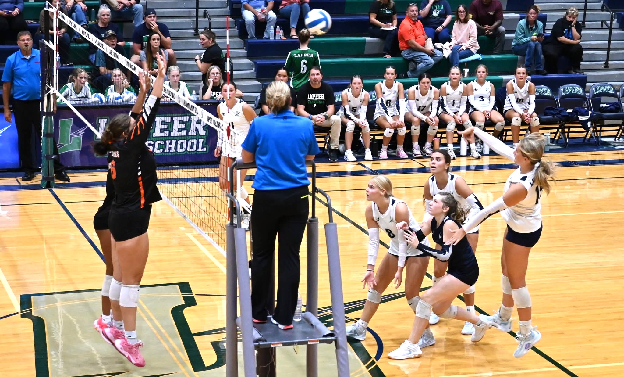 Lapeer varsity volleyball game action inside the high school gym