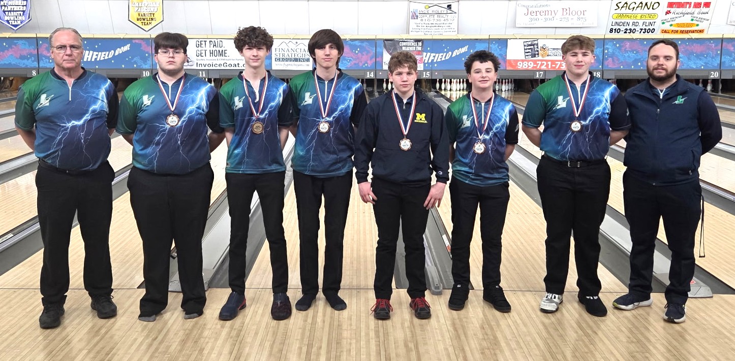 Lapeer boys bowling team in a group standing on the lanes at Richfield Bowl