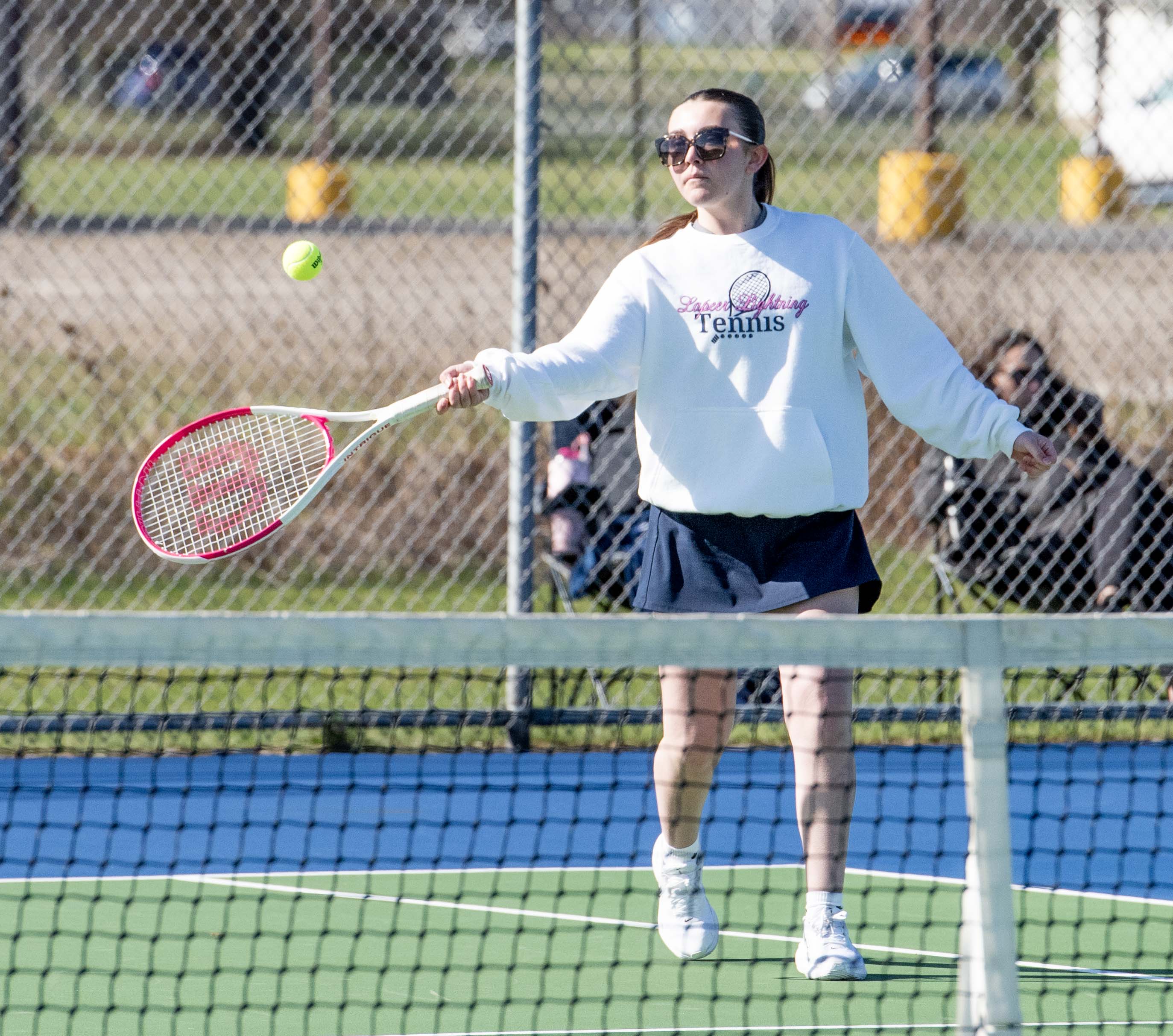 Lapeer girls tennis player returning a serve during a recent match.