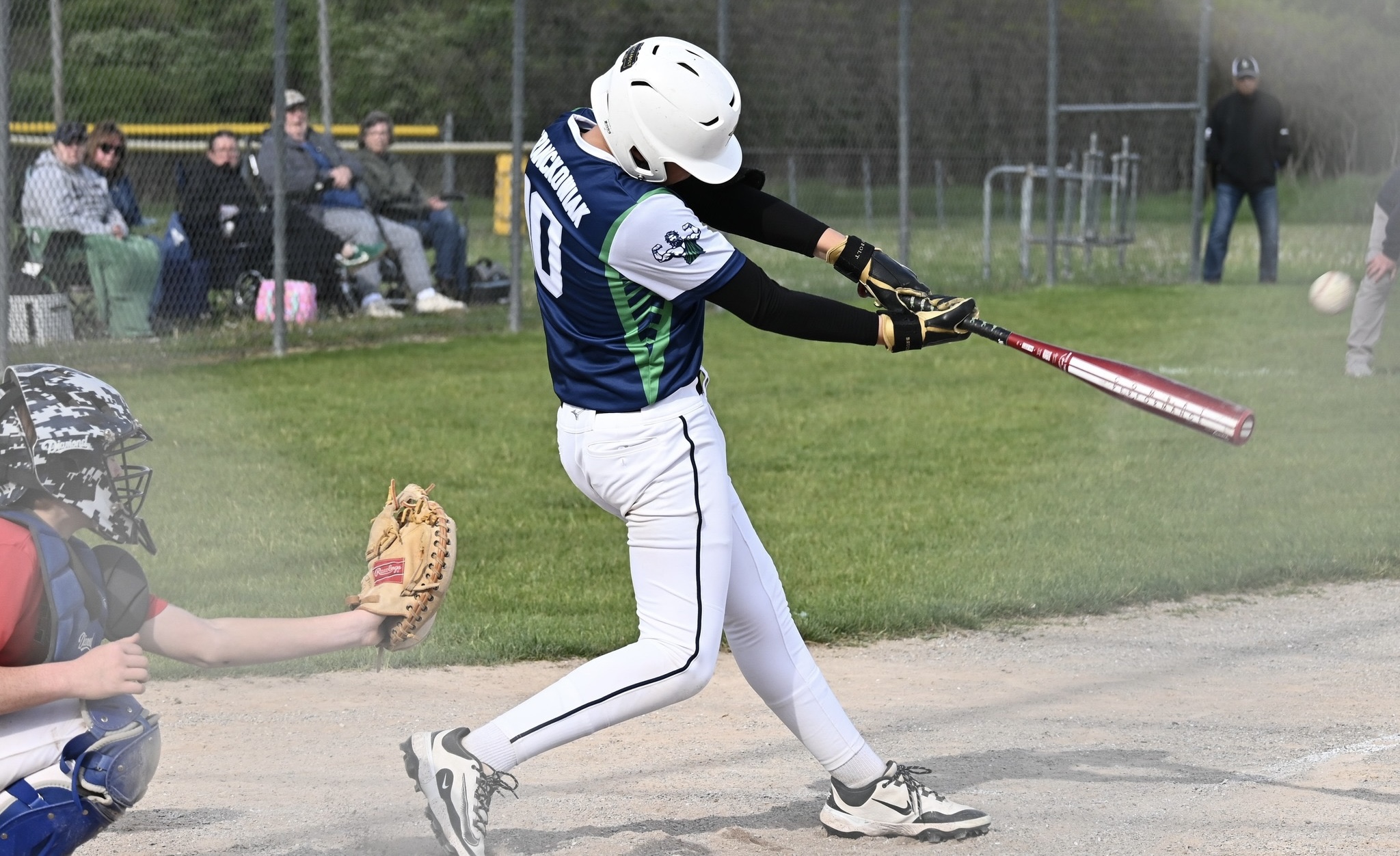 8th grade Lapeer baseball player hitting the ball during a spring 2026 game.