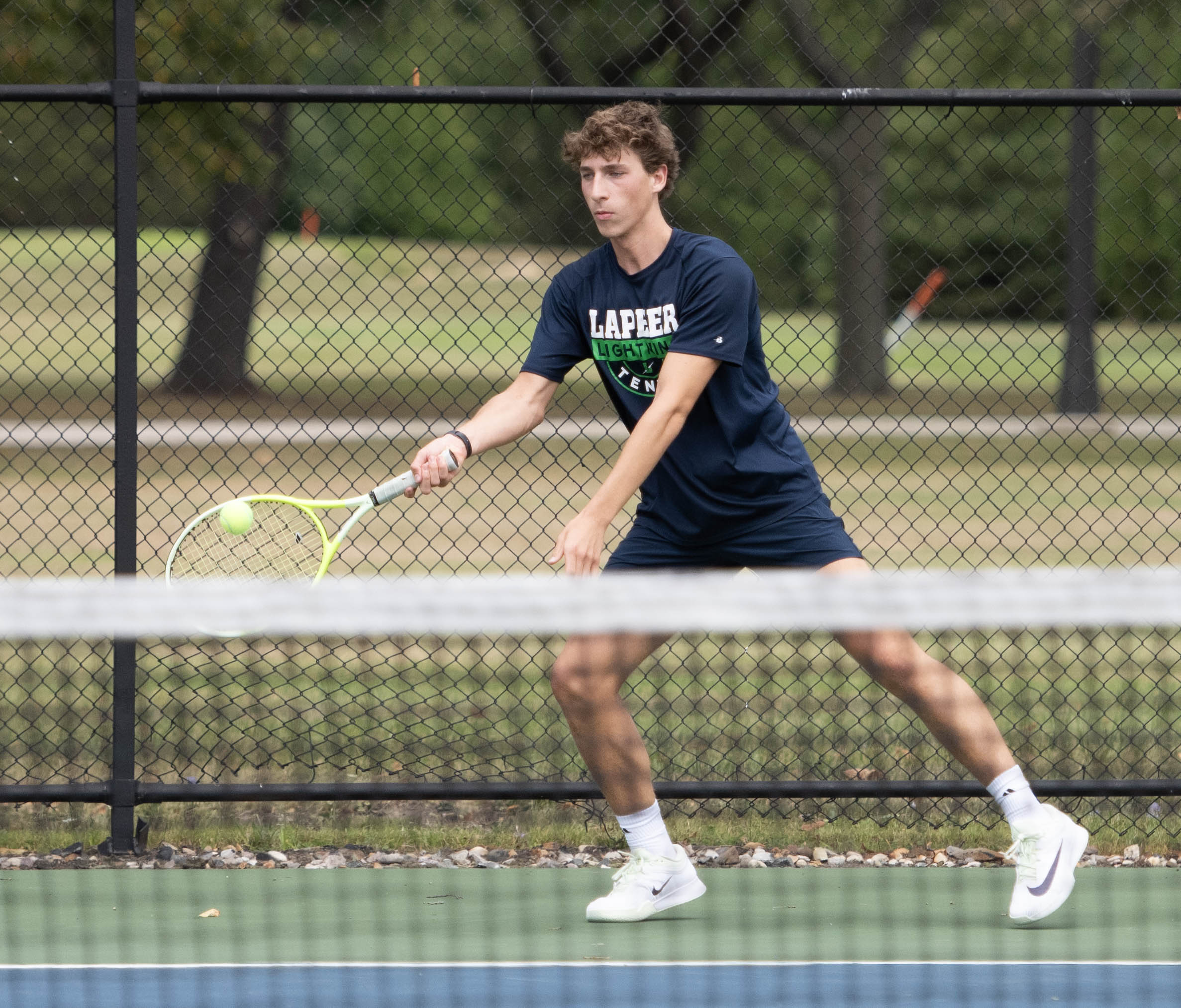 Lapeer boys tennis player Beau Bradford returning a serve during a recent match