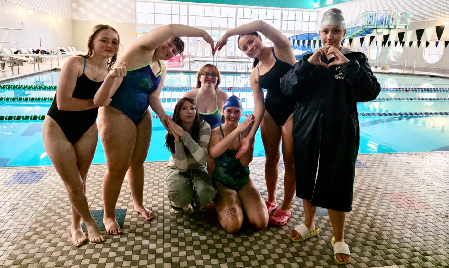 Lapeer girls swim and dive team making a heart shape after a meet in September 2026