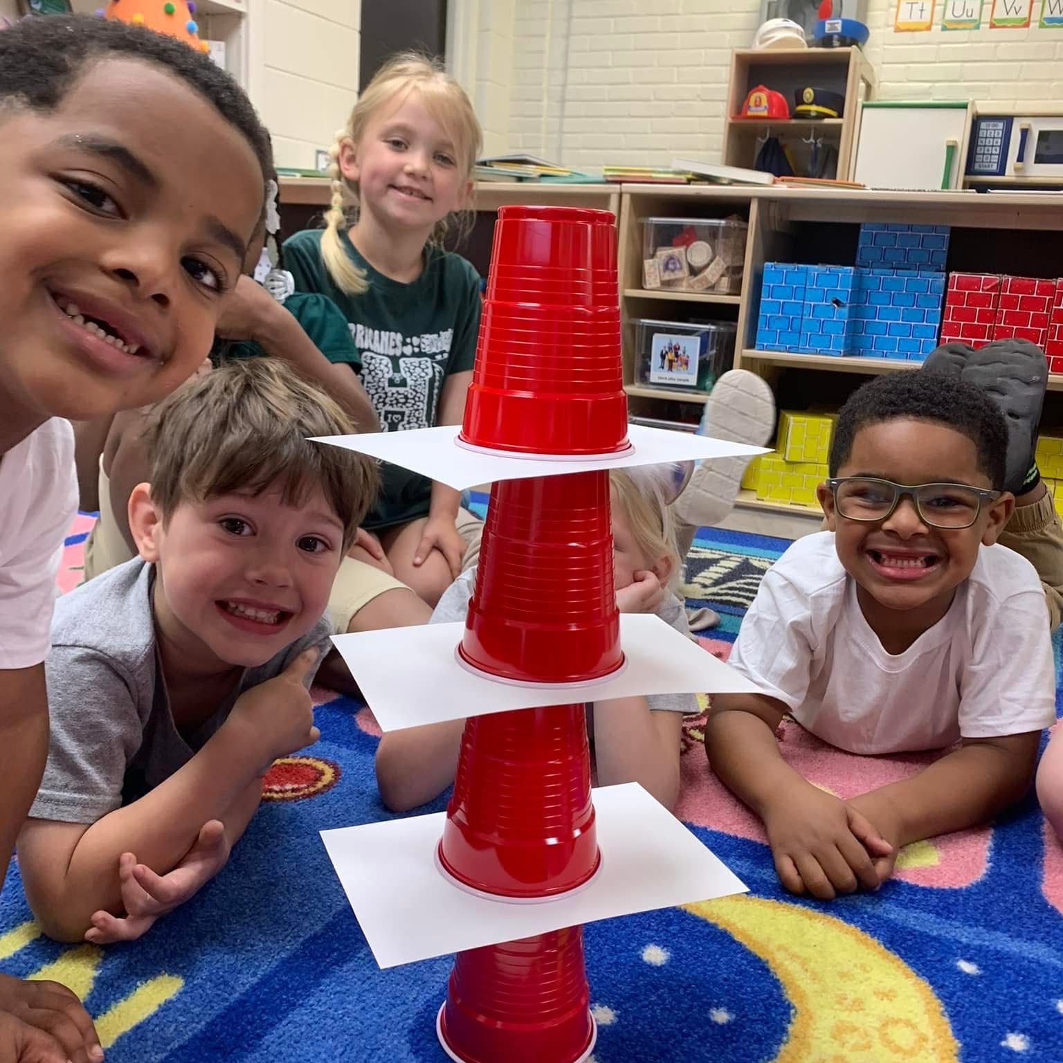 Students stacking cups with paper