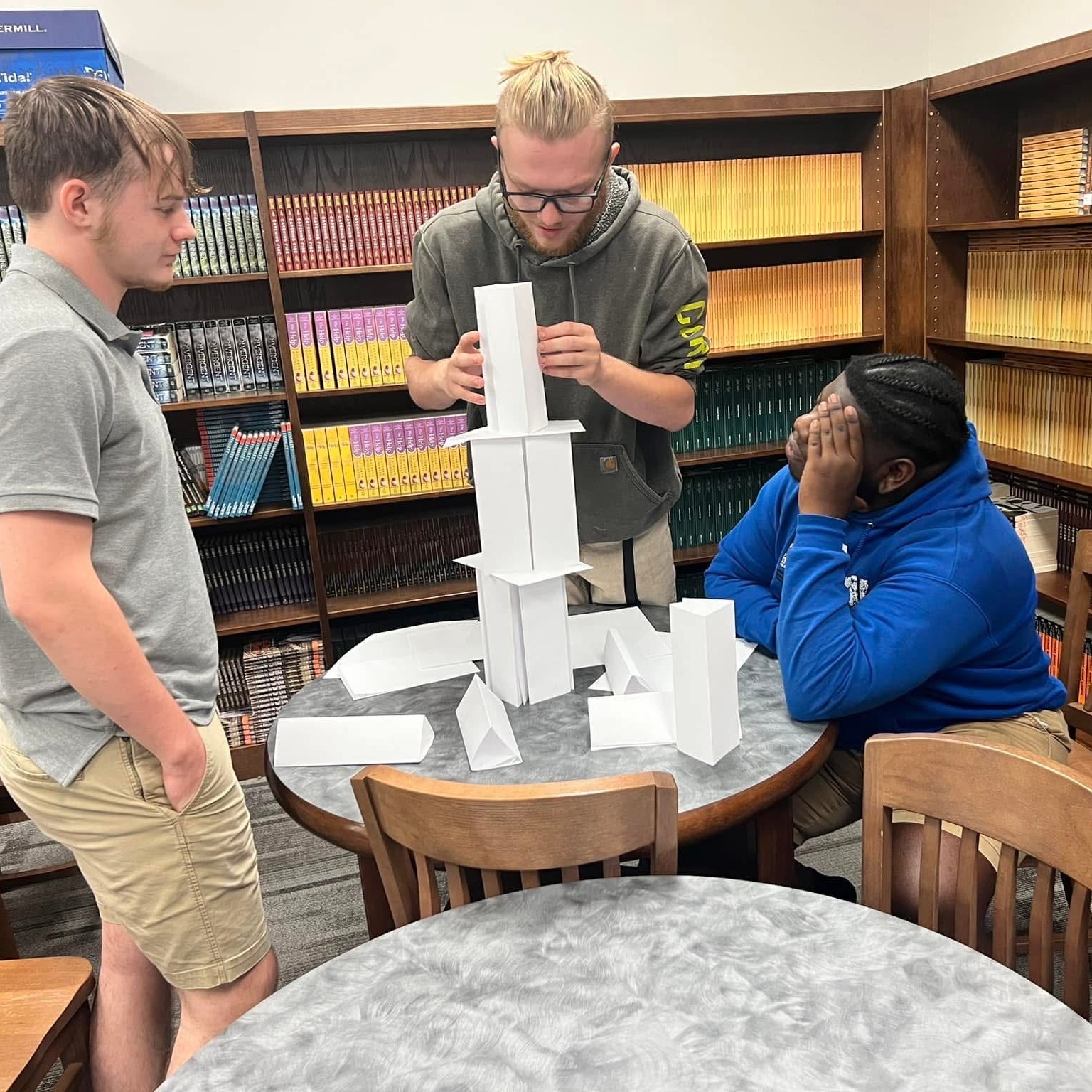 Students working on project making something with paper
