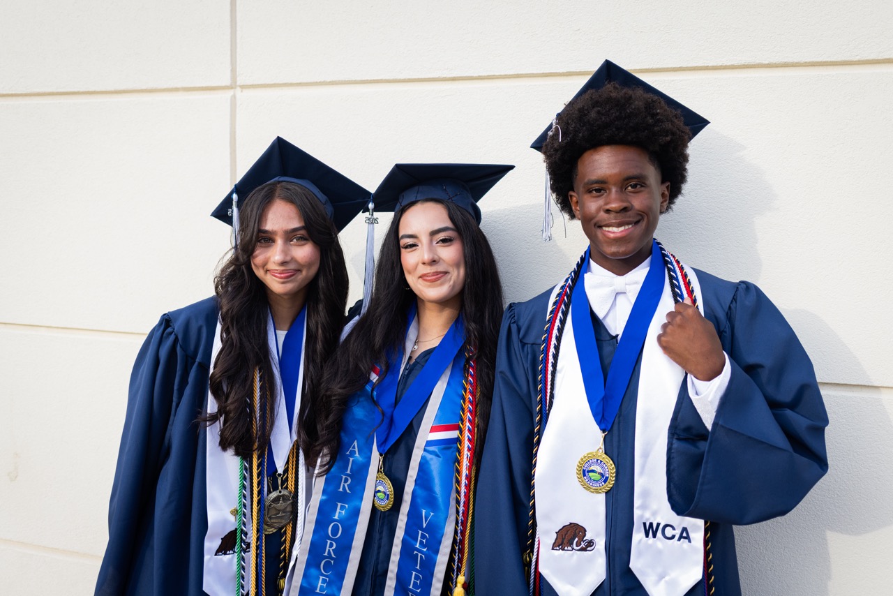 graduates posing and smiling